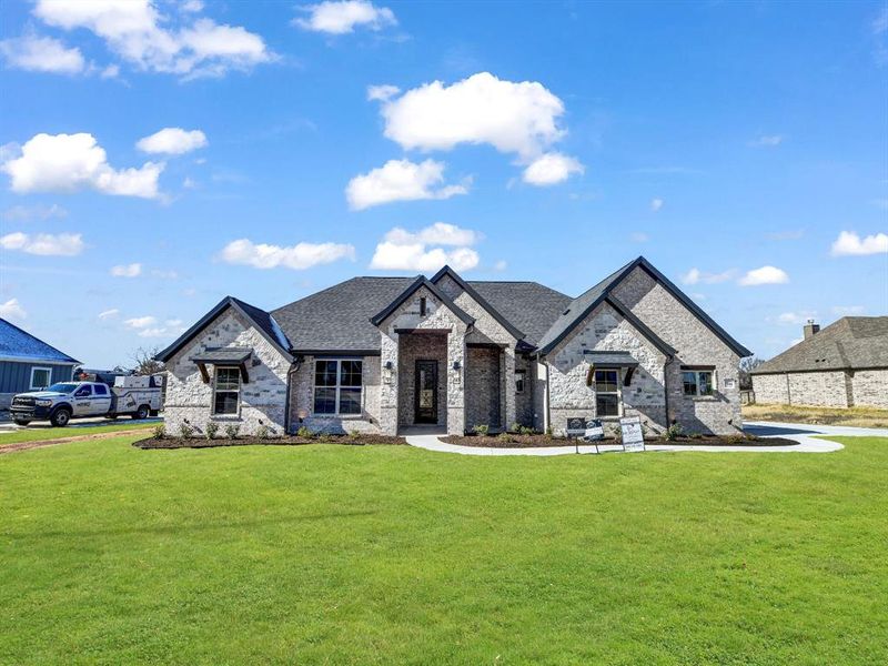 French country style house featuring a front yard