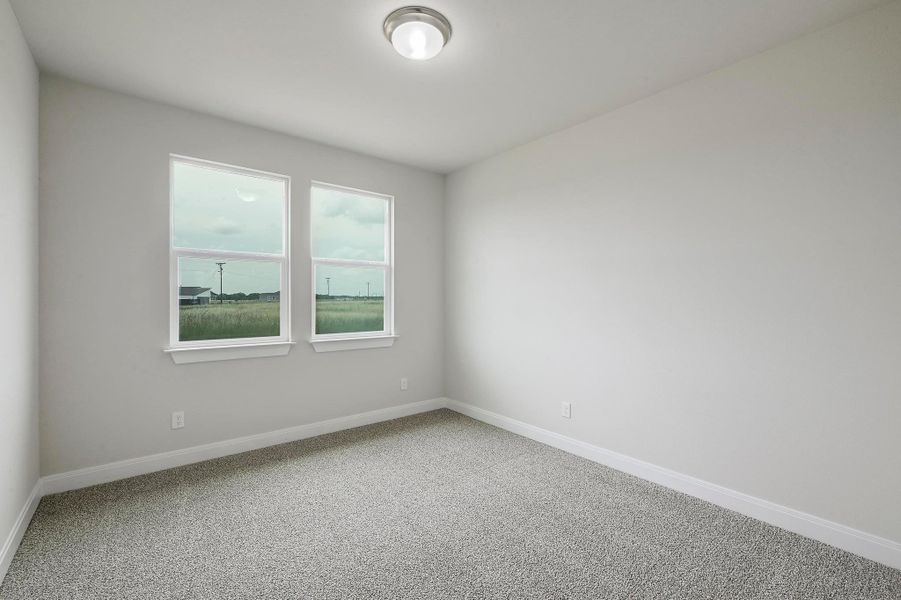 Carpeted empty room featuring baseboards