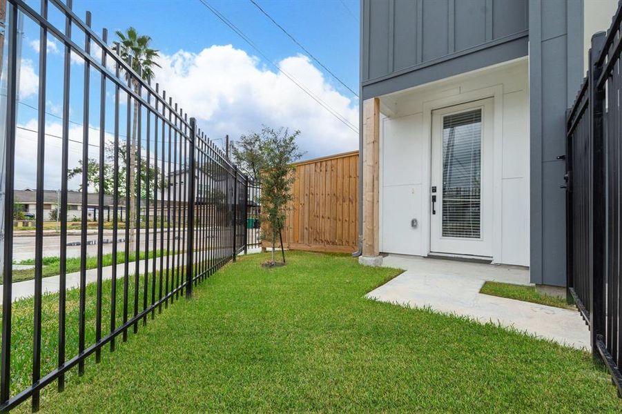 All units have a gated front yard. This corner unit also has a 32x14 side yard.  The wood fence you see in the background of this photo can be removed to combine the front yard and the side yard.