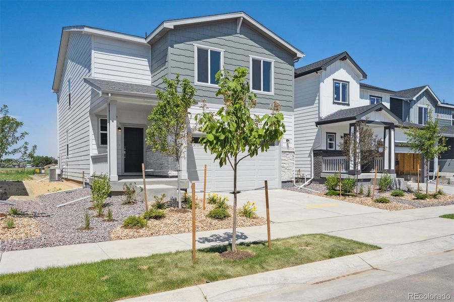 Front exterior of a new home in Farmlore, Brighton, CO, highlighting curb appeal (Image 2). Front exterior of a new home in Farmlore, Brighton, CO, highlighting curb appeal (Image 2).