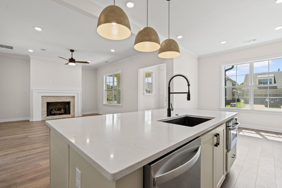 Kitchen featuring a center island with sink, recessed lighting, healthy amount of natural light, stainless steel appliances, and light stone counters Kitchen featuring a center island with sink, recessed lighting, healthy amount of natural light, stainless steel appliances, and light stone counters
