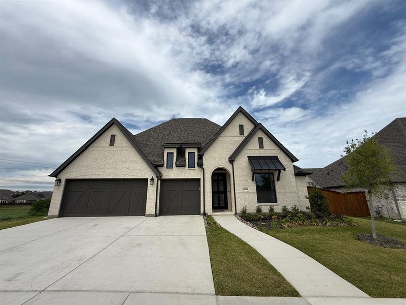 Front exterior of a new home in Ventana, Fort Worth, TX, highlighting curb appeal (Image 1). Front exterior of a new home in Ventana, Fort Worth, TX, highlighting curb appeal (Image 1).