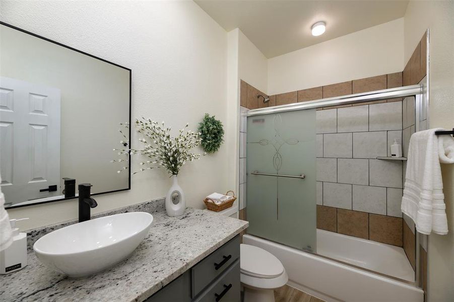 2nd full Bathroom with vanity and enclosed tub / shower combo