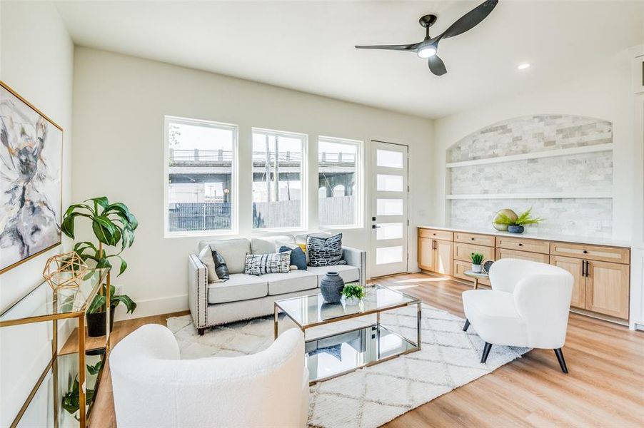 Living room featuring light hardwood / wood-style flooring and ceiling fan