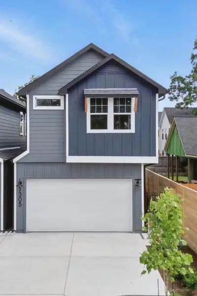 This modern, two-story home features a stylish gray exterior with white trim. It includes a two-car garage and tall fence for privacy. This modern, two-story home features a stylish gray exterior with white trim. It includes a two-car garage and tall fence for privacy.
