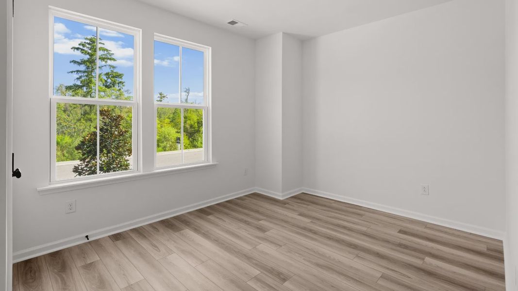 Bedroom 2 in the Easton plan features bright natural light and a spacious layout.