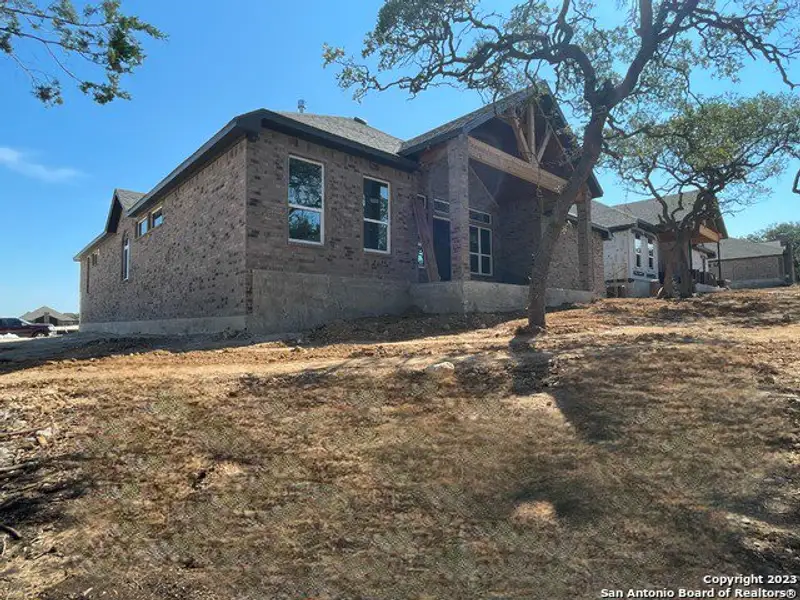 Front exterior of a new home in Sunday Creek at Kinder Ranch, San Antonio, TX, highlighting curb appeal (Image 9). Front exterior of a new home in Sunday Creek at Kinder Ranch, San Antonio, TX, highlighting curb appeal (Image 9).