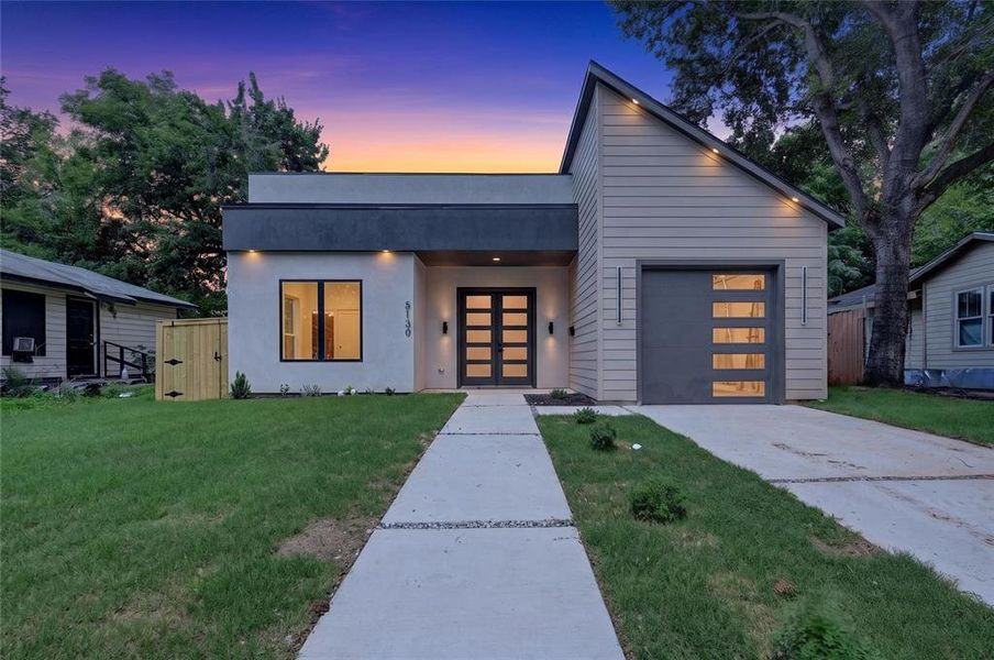 Modern architectural facade featuring a contrasting flat roofline and pitched roof section Modern architectural facade featuring a contrasting flat roofline and pitched roof section