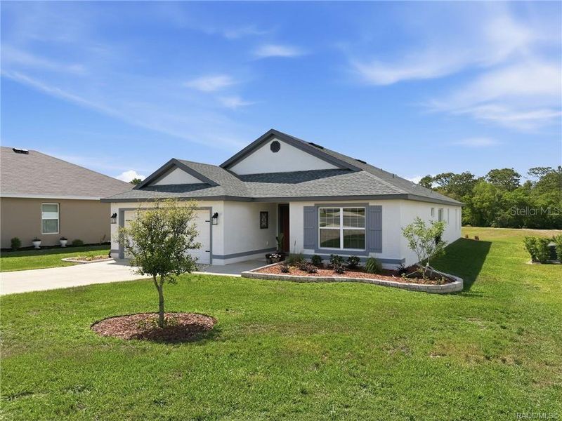 Front exterior of a new home in The Fairways At Twisted Oaks, Beverly Hills, FL, highlighting curb appeal (Image 22).