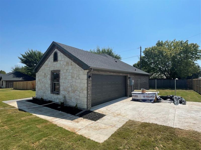 Garage featuring a lawn