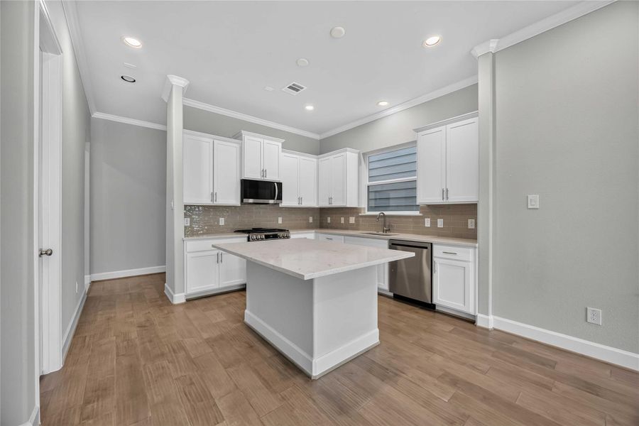 Form Meets Function – Quartz counters and stainless appliances give this hardworking kitchen a polish that holds up to daily life.
