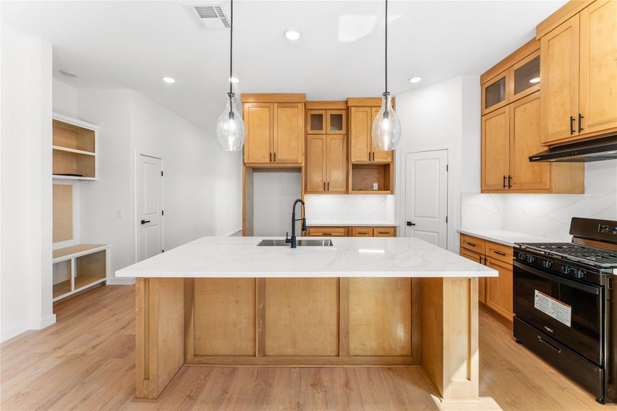 This beautiful kitchen includes a new all black gas stove This beautiful kitchen includes a new all black gas stove