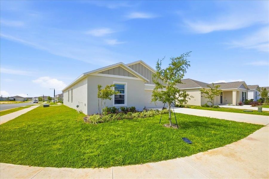 Front exterior of a new home in Hunt Club Groves, Lake Wales, FL, highlighting curb appeal (Image 2).