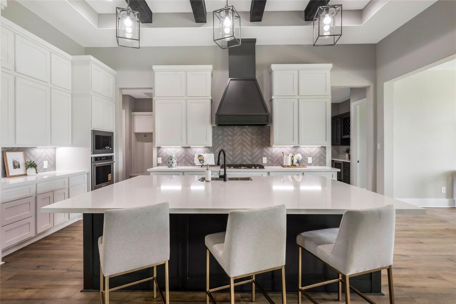The room is accented by elegant pendant lighting and a herringbone backsplash, creating a contemporary and inviting space. The room is accented by elegant pendant lighting and a herringbone backsplash, creating a contemporary and inviting space.