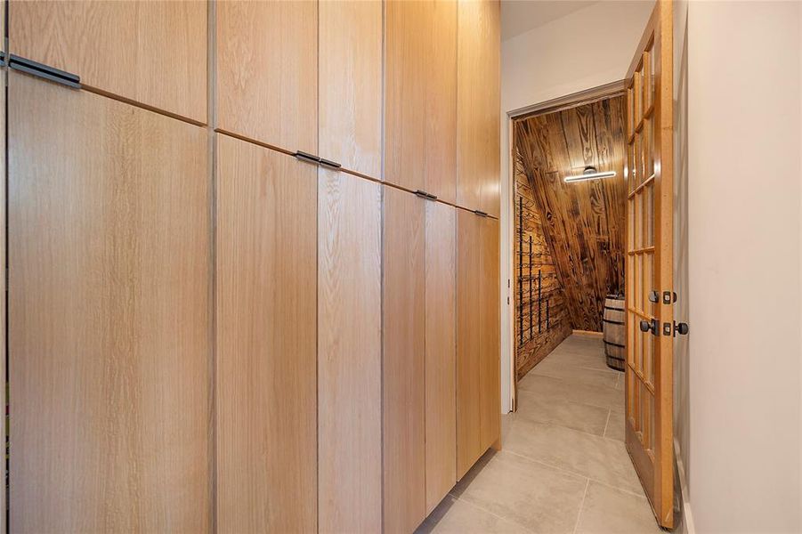 Hallway with wood walls and light tile patterned floors