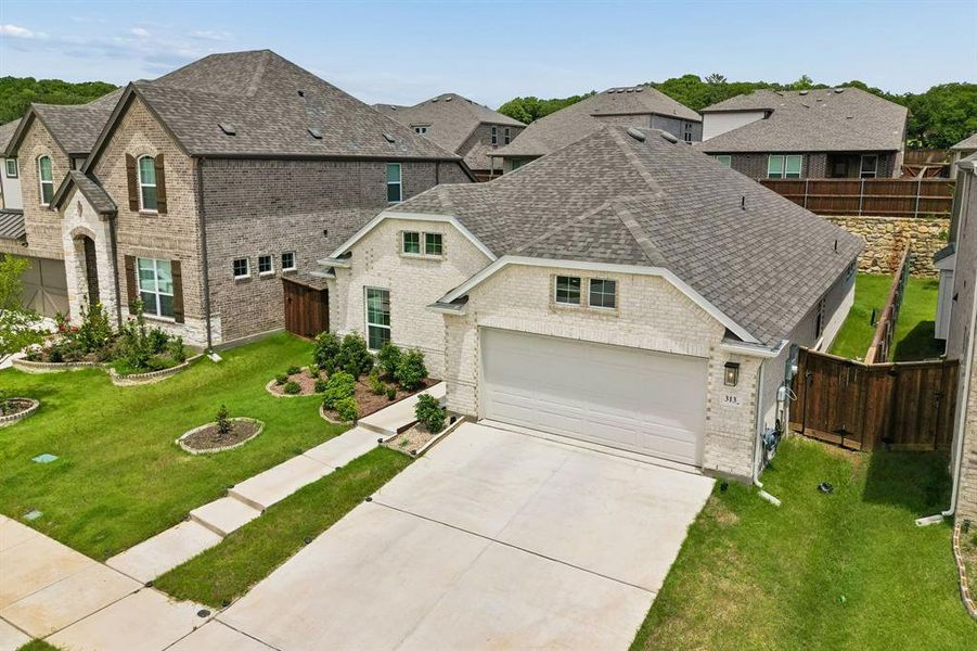 Contemporary single-story residence featuring a light brick exterior and a two-car garage