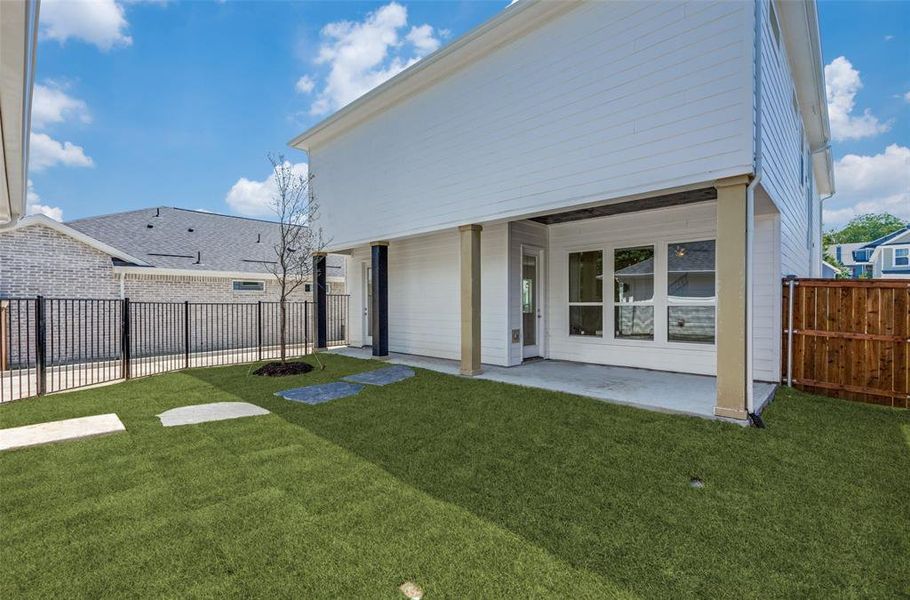 Rear view of house with a patio and a yard