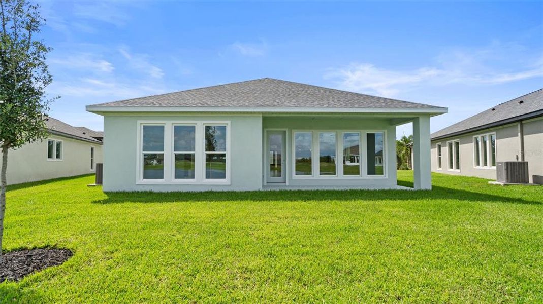 Front exterior of a new home in Magnolia Bay 50', Nokomis, FL, highlighting curb appeal (Image 1). Front exterior of a new home in Magnolia Bay 50', Nokomis, FL, highlighting curb appeal (Image 1).