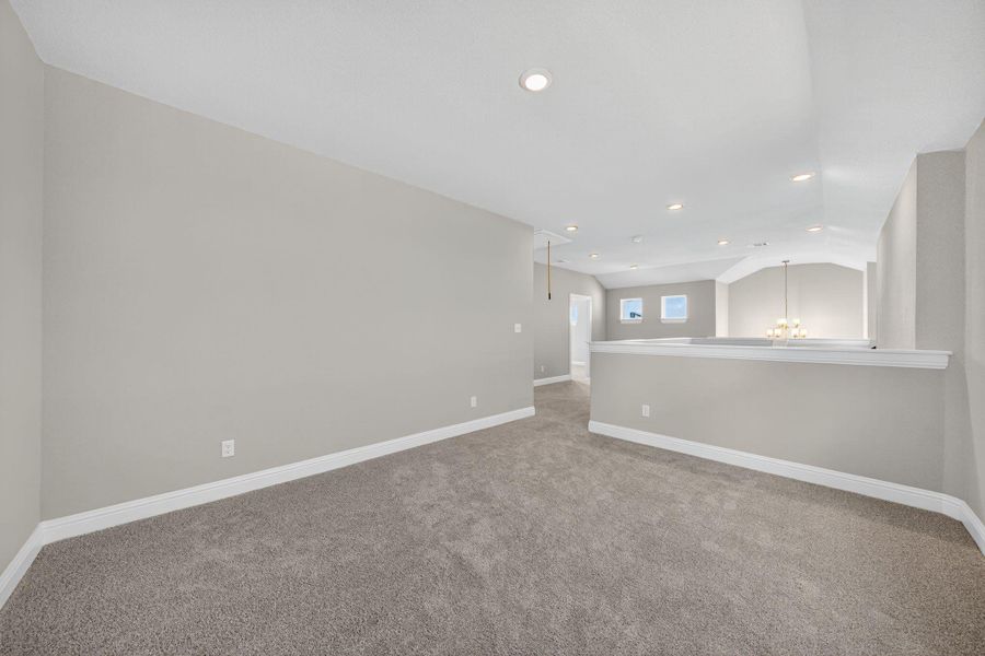 Spare room with a chandelier, recessed lighting, carpet flooring, and vaulted ceiling Spare room with a chandelier, recessed lighting, carpet flooring, and vaulted ceiling