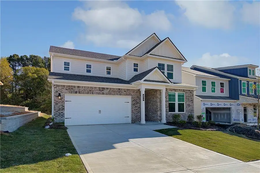 Front exterior of a new home in Abbotts Crossing, Conyers, GA, highlighting curb appeal (Image 1).
