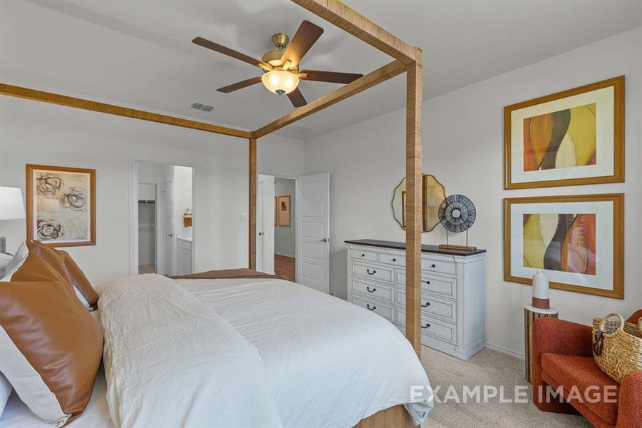 Carpeted bedroom with ceiling fan and ensuite bathroom