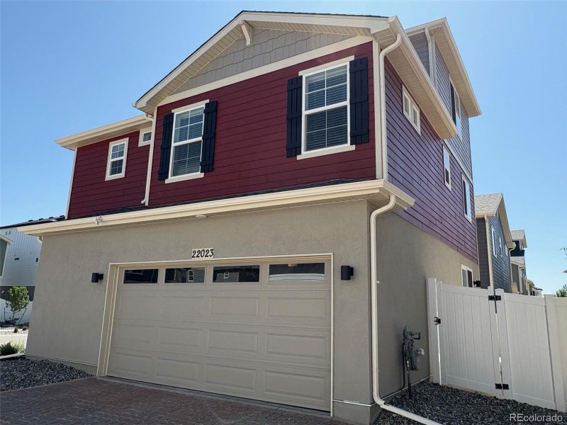 Front exterior of a new home in Green Valley Ranch, Aurora, CO, highlighting curb appeal (Image 1).