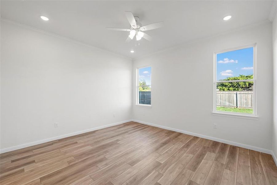 Spare room featuring crown molding, light wood finished floors, recessed lighting, and ceiling fan