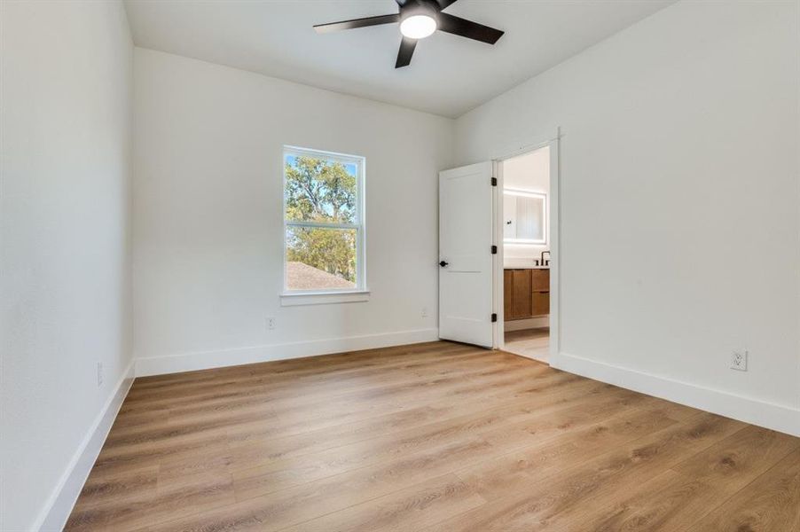 Spare room featuring light wood-style floors and a ceiling fan