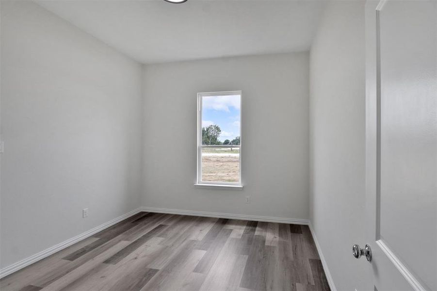 Spare room featuring hardwood / wood-style flooring