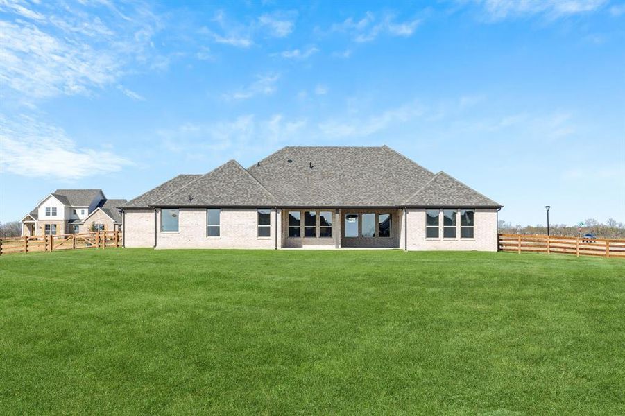 Rear view of property featuring a fenced backyard, a patio area, and brick siding Rear view of property featuring a fenced backyard, a patio area, and brick siding