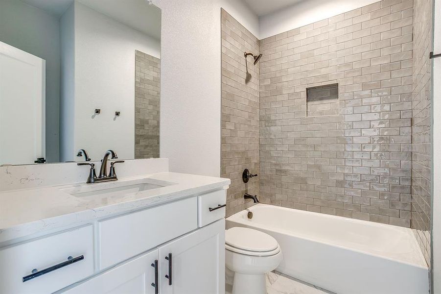 Bathroom with vanity and bathing tub / shower combination