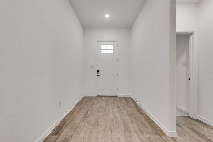 Foyer with light hardwood / wood-style floors