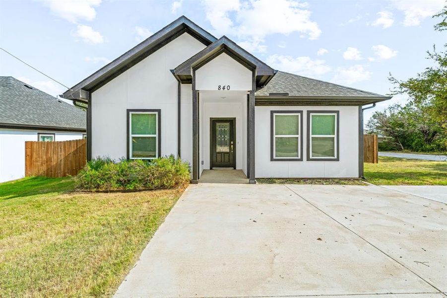 View of front of home with stucco siding and a shingled roof View of front of home with stucco siding and a shingled roof