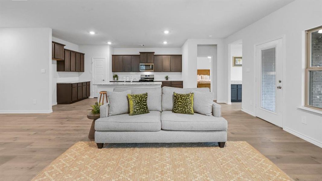 Living area with recessed lighting and light wood finished floors