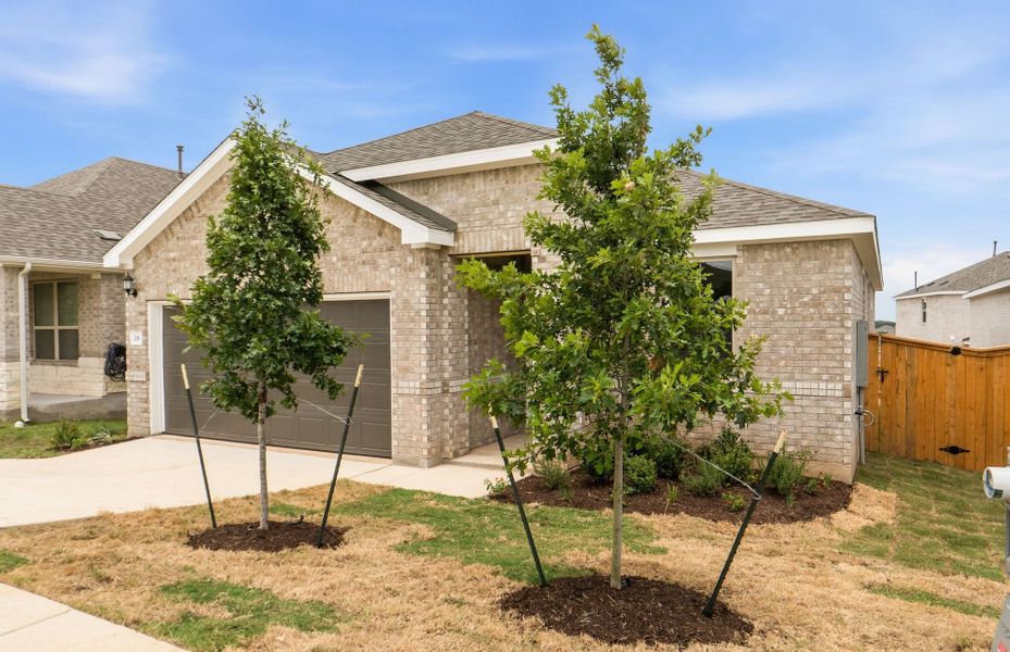 Front exterior of a new home in La Cima, San Marcos, TX, highlighting curb appeal (Image 21).