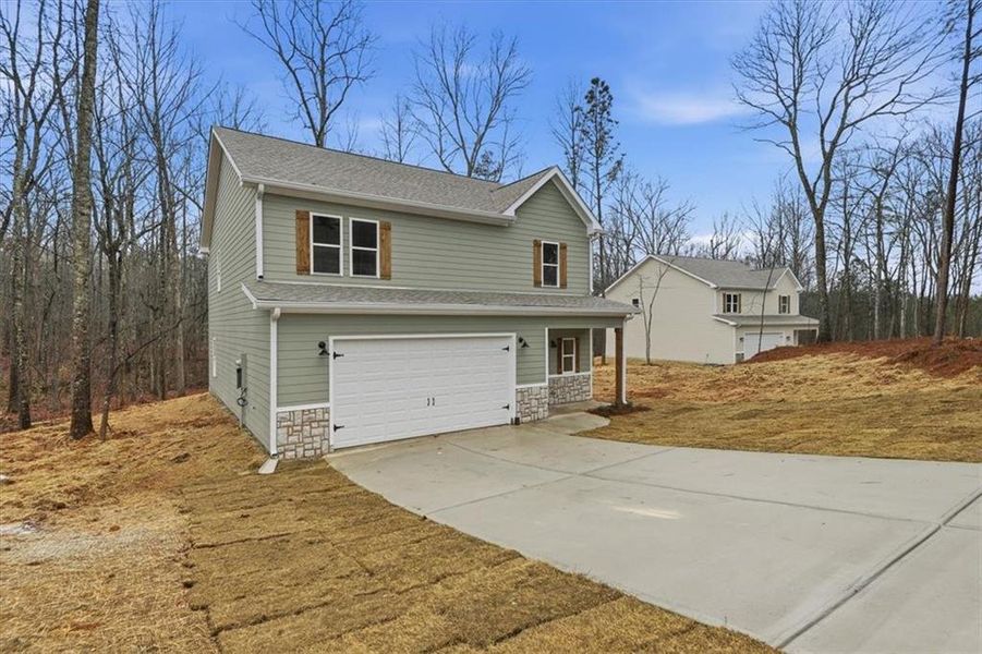 Front exterior of a new home in , Carrollton, GA, highlighting curb appeal (Image 21).