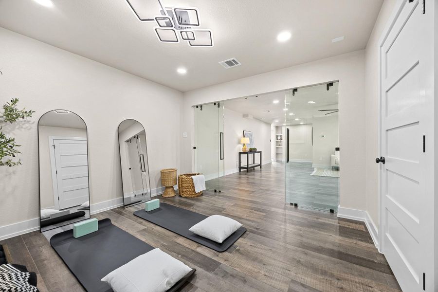 Workout area with arched walkways, recessed lighting, and wood finished floors Workout area with arched walkways, recessed lighting, and wood finished floors