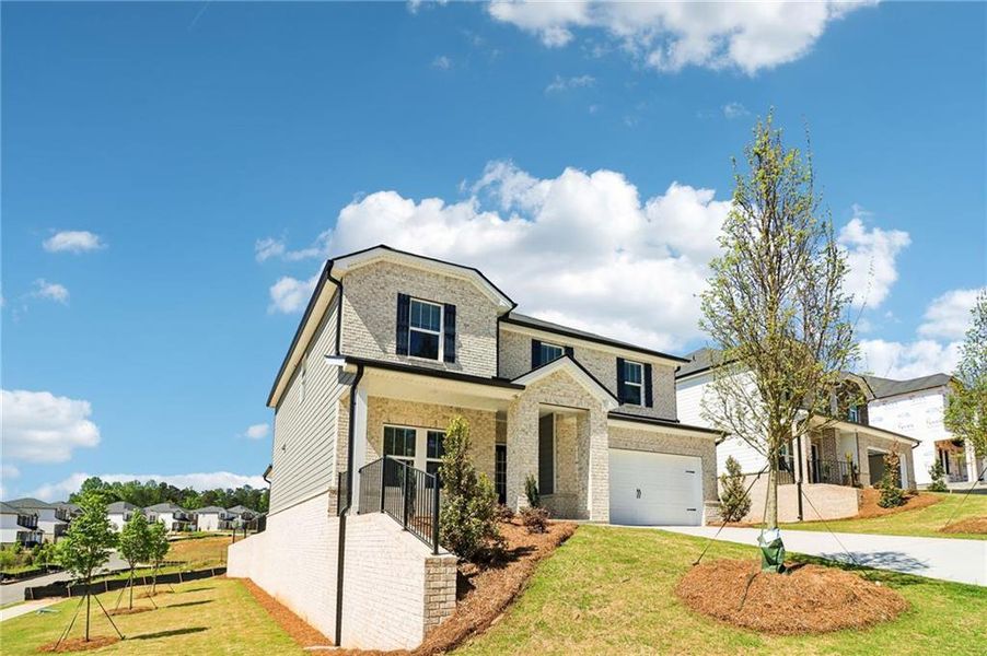 Front exterior of a new home in Harmony Manor, Fairburn, GA, highlighting curb appeal (Image 2). Front exterior of a new home in Harmony Manor, Fairburn, GA, highlighting curb appeal (Image 2).