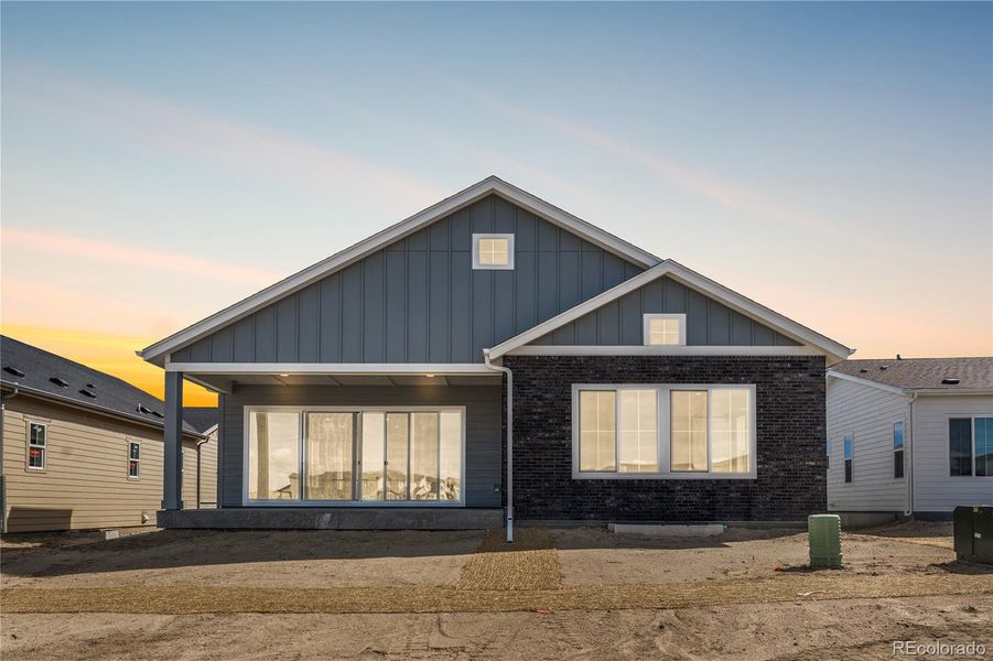 Front exterior of a new home in Reserve at The Canyons, Castle Pines, CO, highlighting curb appeal (Image 1).