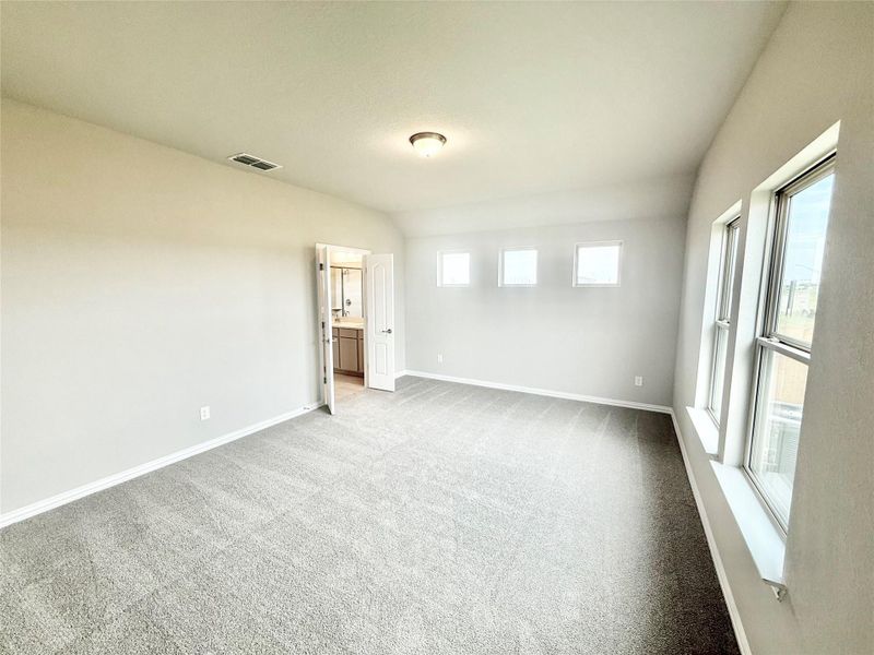 Spare room featuring baseboards and carpet flooring Spare room featuring baseboards and carpet flooring