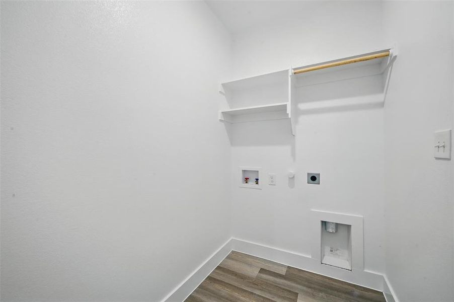 Clothes washing area with electric dryer hookup, dark wood-style floors, washer hookup, baseboards, and hookup for a gas dryer