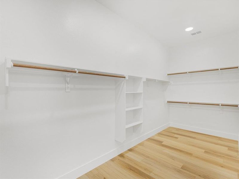 Walk in closet featuring light wood-type flooring Walk in closet featuring light wood-type flooring