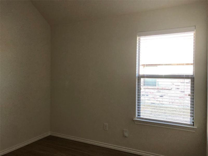 Unfurnished room with dark hardwood / wood-style floors