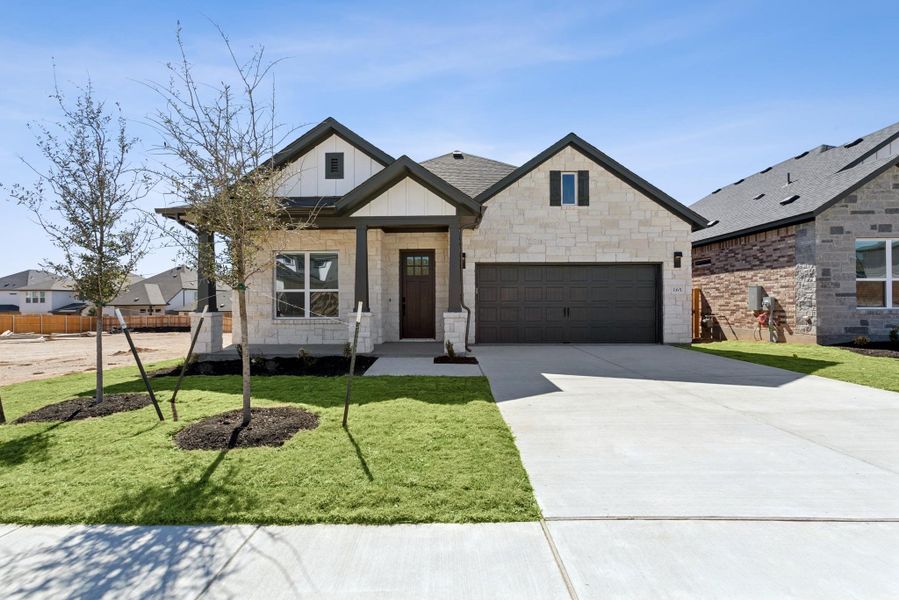 Front exterior of a new home in Heritage, Dripping Springs, TX, highlighting curb appeal (Image 1). Front exterior of a new home in Heritage, Dripping Springs, TX, highlighting curb appeal (Image 1).