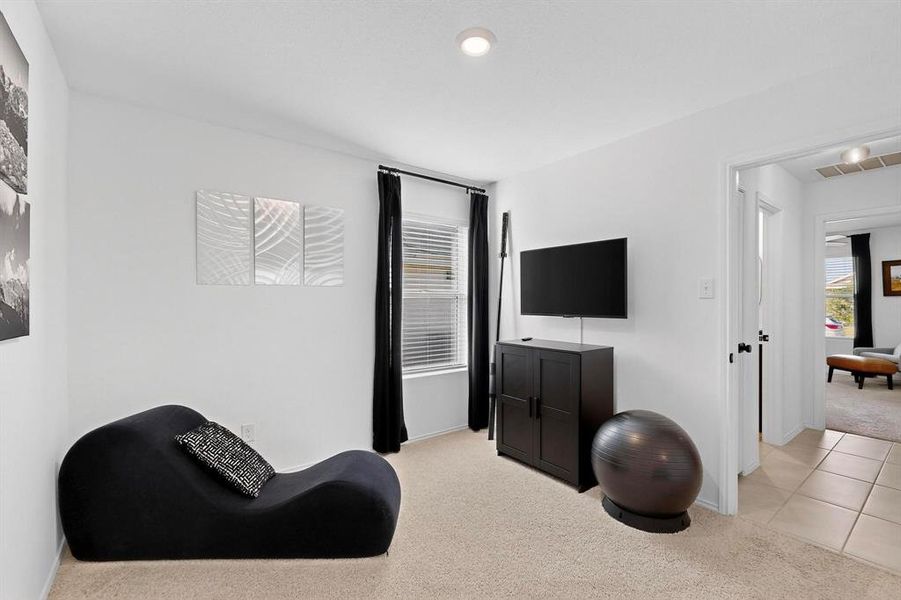 Living area with light carpet, light tile patterned floors, and recessed lighting Living area with light carpet, light tile patterned floors, and recessed lighting