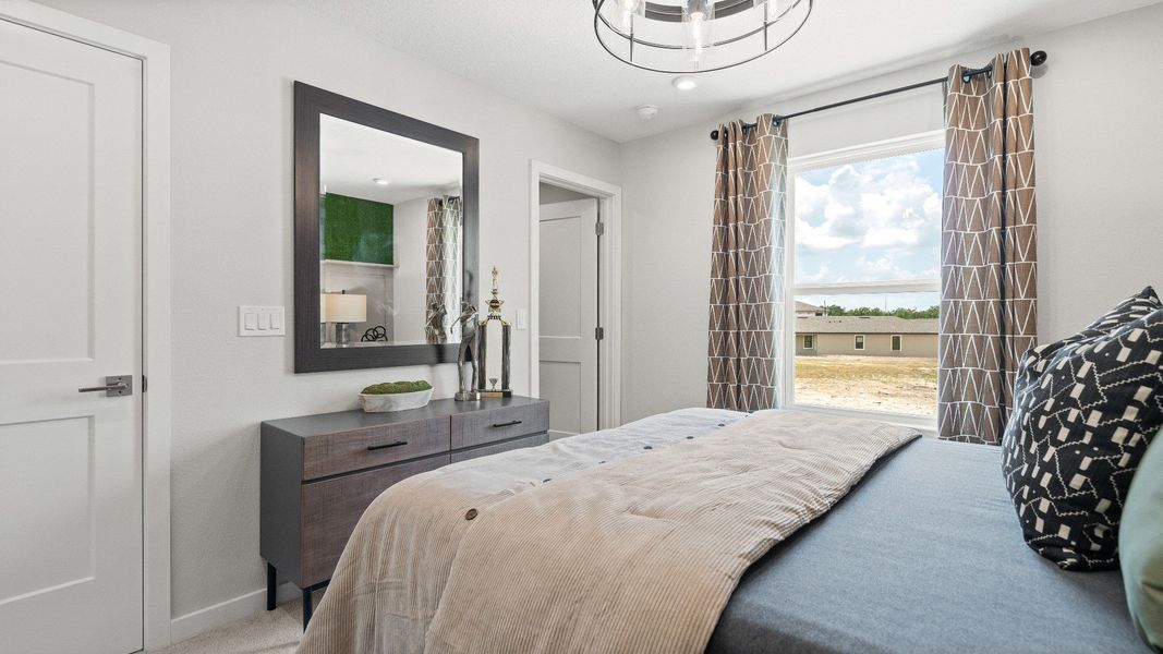 Golf themed bedroom overlooking the course New Construction Home in Winter Haven by DRB Homes in Willowbrook North