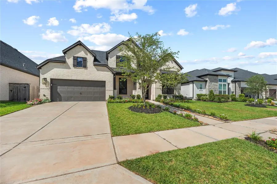 Front exterior of a new home in Sienna, Missouri City, TX, highlighting curb appeal (Image 2).