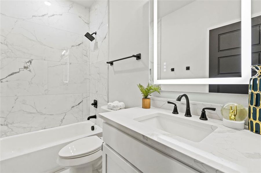 Full bathroom with vanity and shower / bath combination Full bathroom with vanity and shower / bath combination