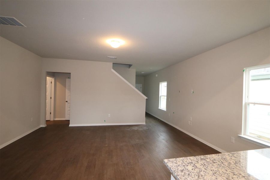 Spare room with dark wood-type flooring