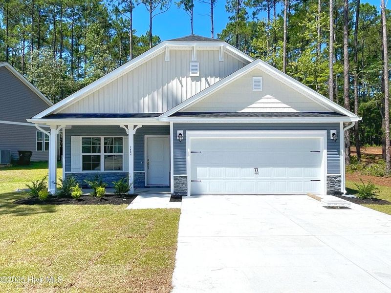 Front exterior of a new home in Mill Creek Cove, Bolivia, NC, highlighting curb appeal (Image 1). Front exterior of a new home in Mill Creek Cove, Bolivia, NC, highlighting curb appeal (Image 1).